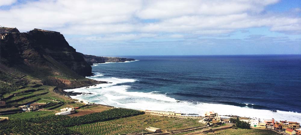 Wave crashing gently on a semi-rocky shoreline