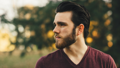Man with beard looking to the left
