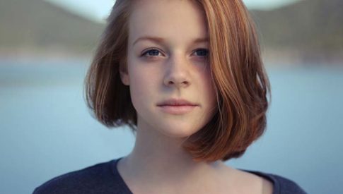 Young woman with neutral expression looking directly at camera
