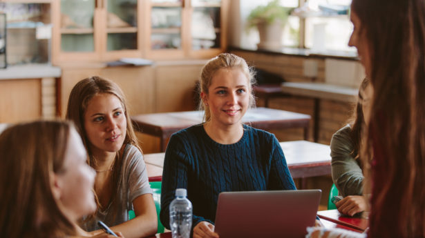 Students chatting in university classroom